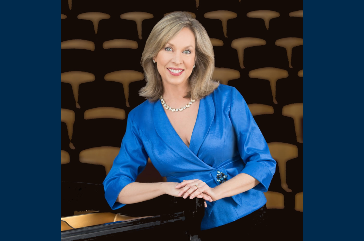 photo of woman in blue top leaning against piano